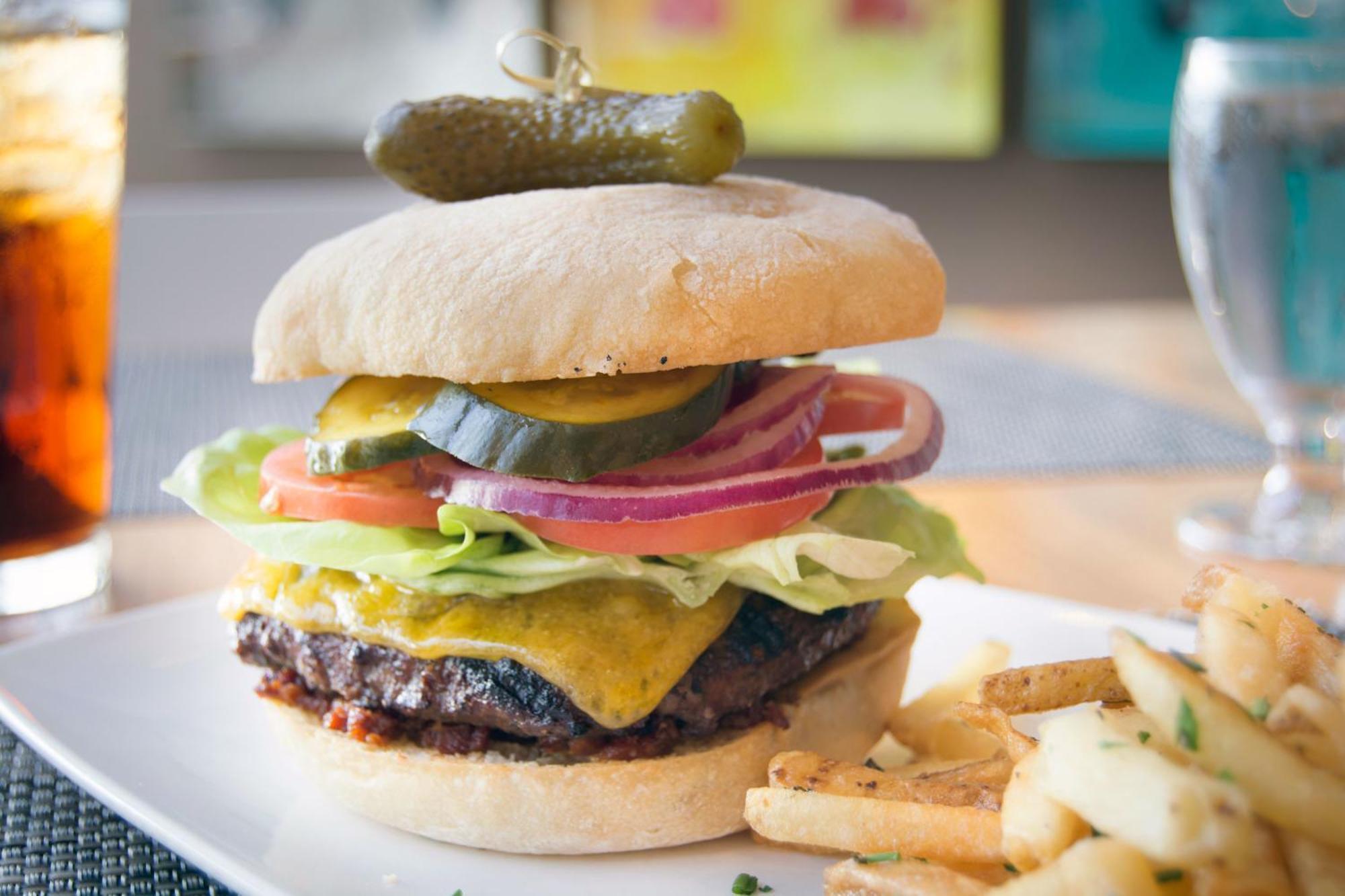 Hotel Murano Tacoma Buitenkant foto A cheeseburger with lettuce, tomato, onion, and pickle